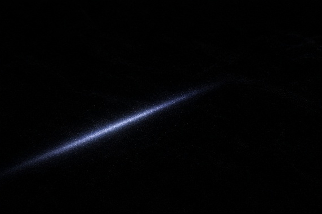 A final beam disappearing into black velvet